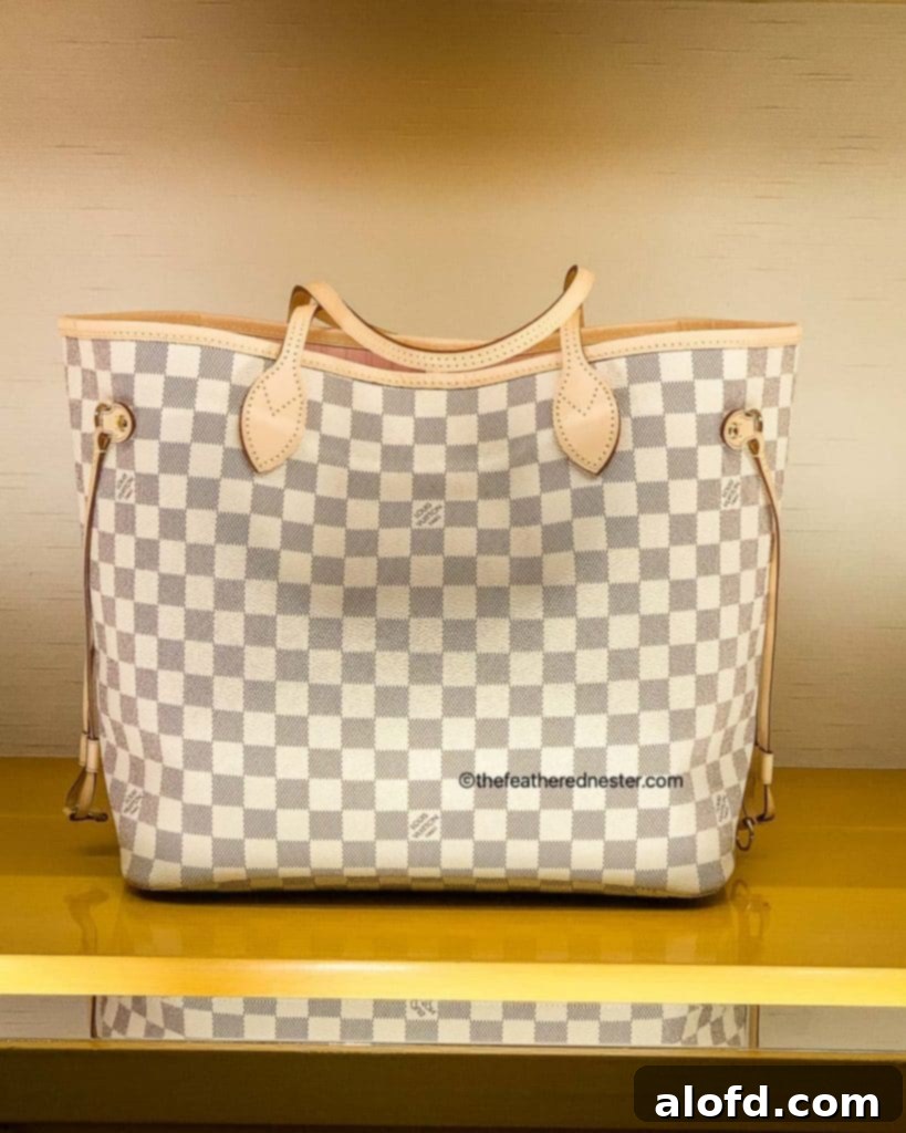 My Unfiltered Review of the Louis Vuitton Neverfull 4 A beautiful Louis Vuitton Neverfull MM tote bag in Damier Azur canvas, perfectly sized for everyday elegance.