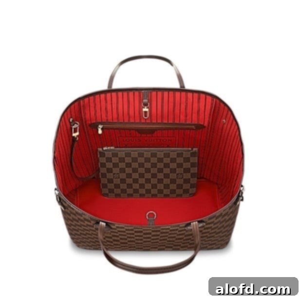 My Unfiltered Review of the Louis Vuitton Neverfull 7 The vibrant cerise (rouge) interior of a Louis Vuitton Neverfull GM in Damier Ebene, showcasing the spacious design and the attached pochette ring.
