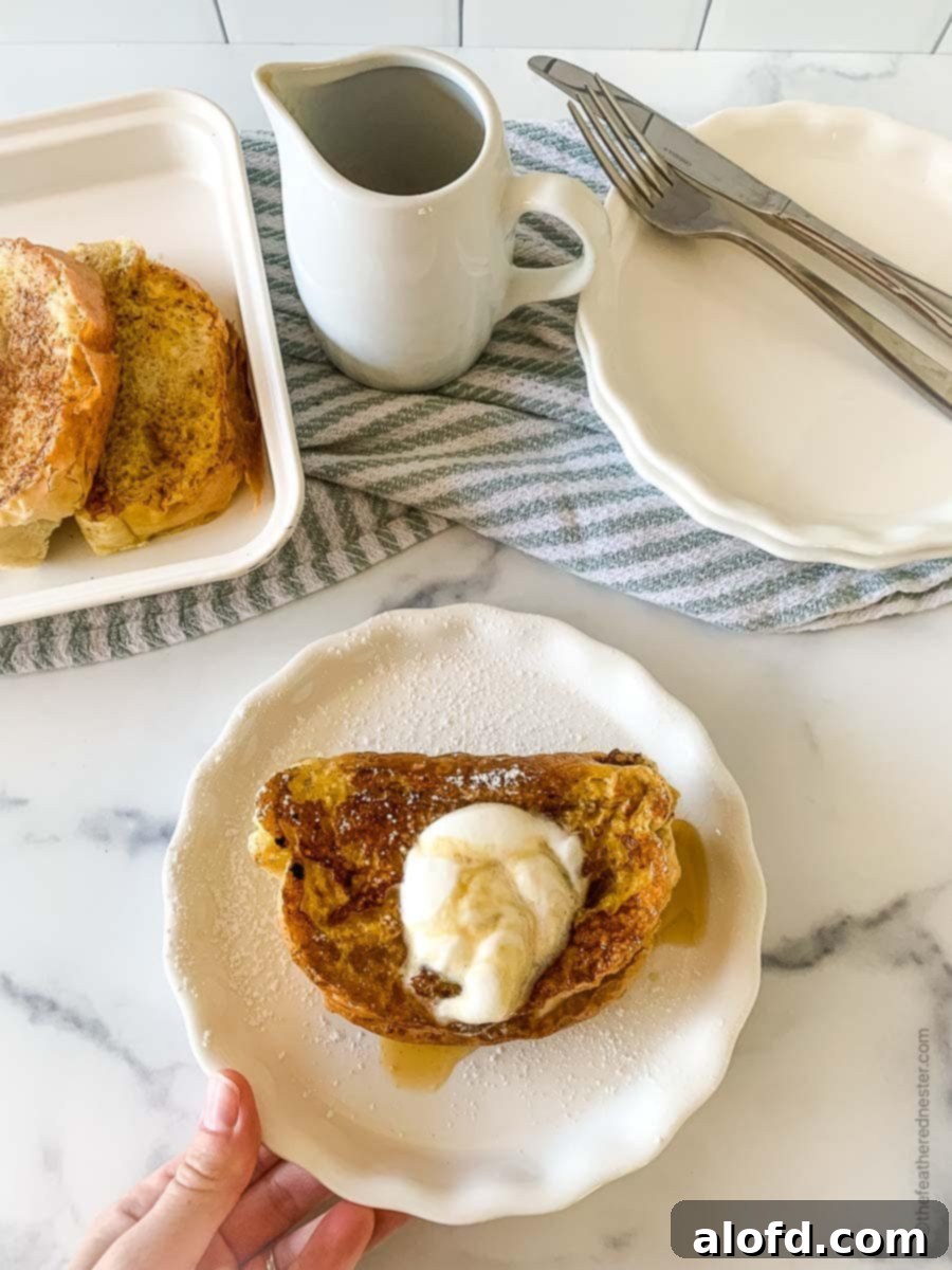 Tangy Sourdough French Toast 7 Sweet breakfast on a small white plate at a table setting.