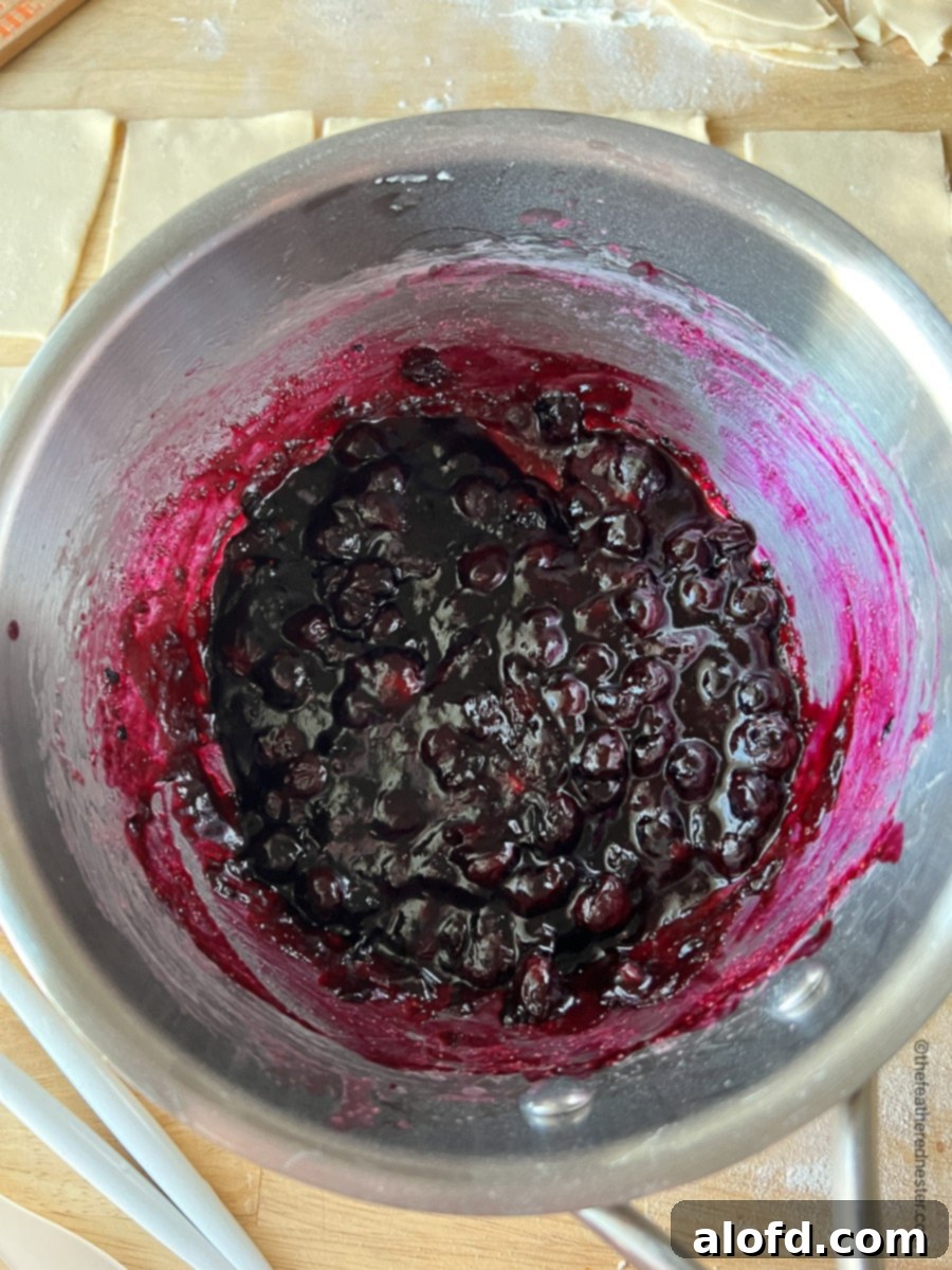 Untamed Berry Breakfast Pastries 4 A saucepan filled with rich, cooked blueberry hand pie filling, ready to be cooled and used.