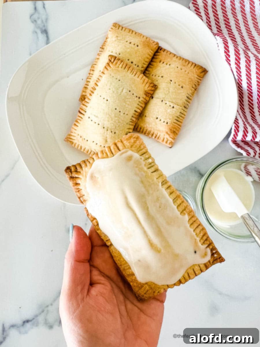 Untamed Berry Breakfast Pastries 7 A close-up shot of a perfectly iced homemade toaster pastry, highlighting its beautiful texture and glaze.