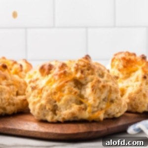 Bisquick Garlic Cheddar Biscuits 18 Cheddar biscuits on a wooden platter.
