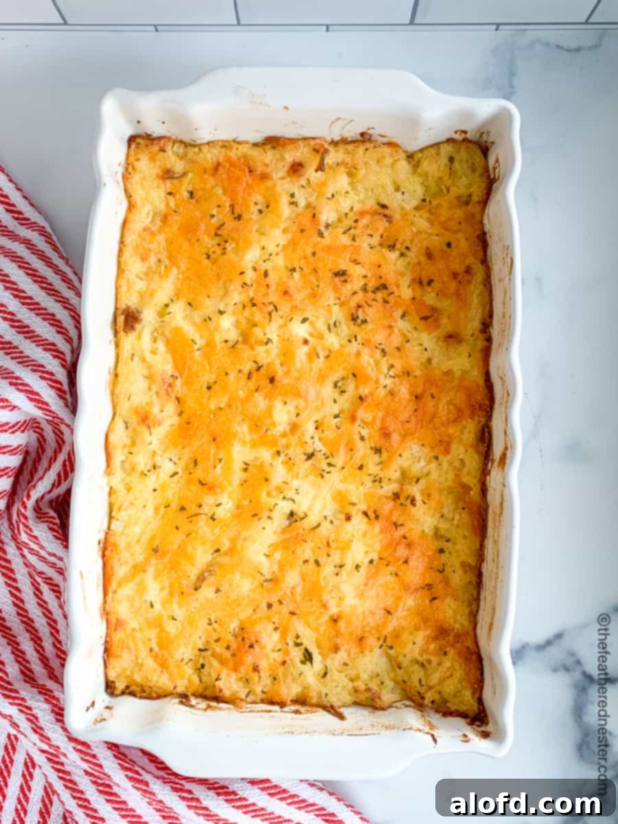 Homestyle Hash Brown Casserole 7 A large white casserole dish filled with golden brown, bubbly hash brown casserole.