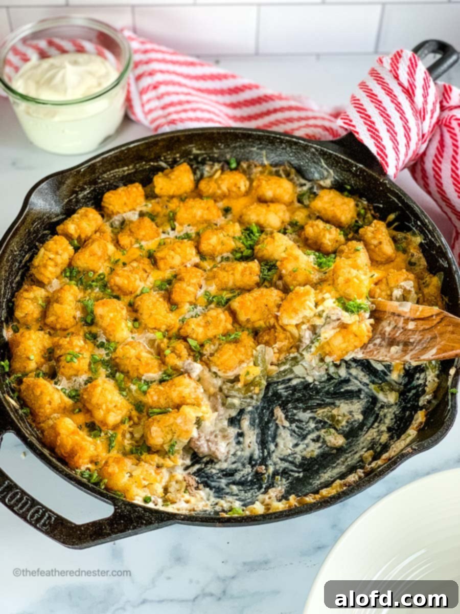 Crispy Tater Tot Green Bean Bake 7 A cast iron skillet with green bean casserole with tater tots.