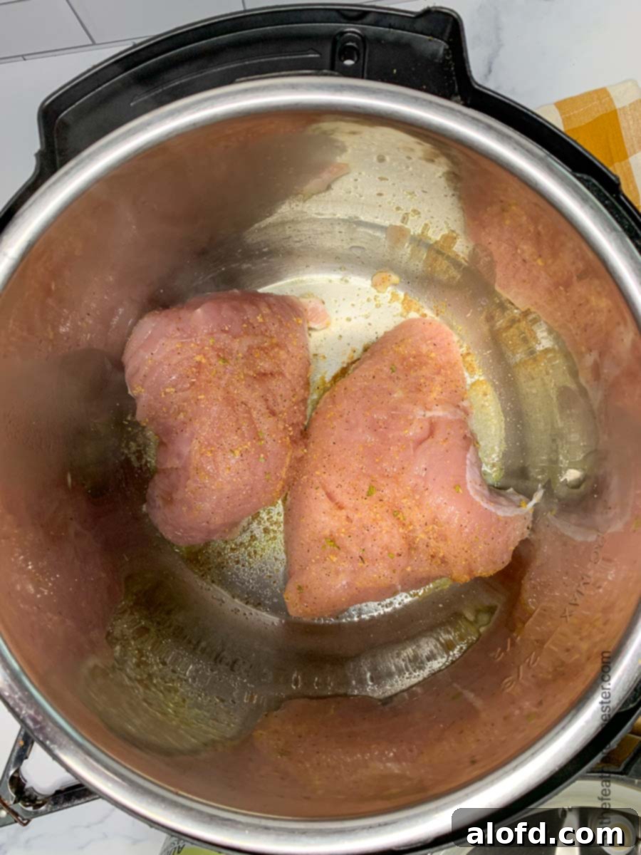 Juicy Instant Pot Turkey Tenderloin 4 Turkey tenderloin being seared to a golden brown in an Instant Pot, building delicious flavor.