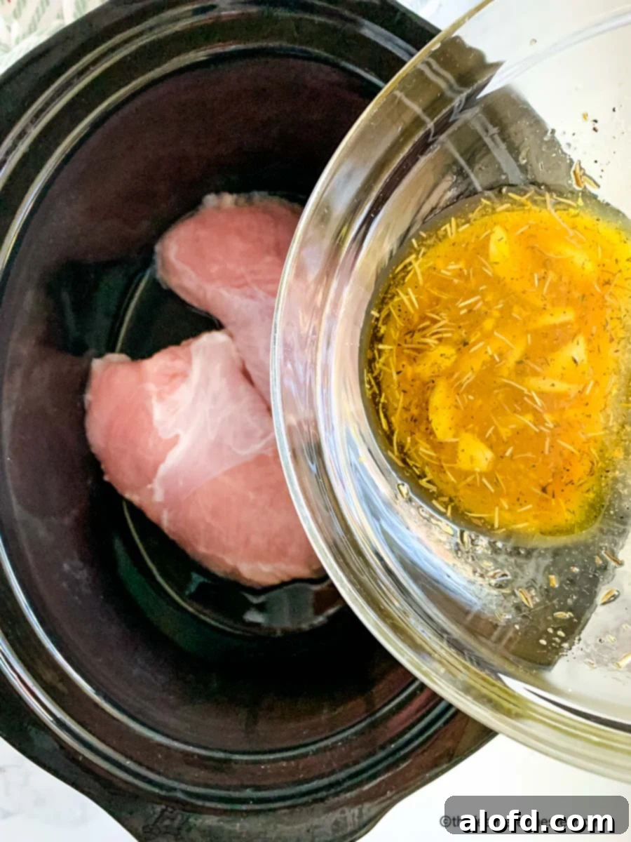 Pouring a bowl of turkey marinade into a slow cooker containing turkey tenderloins.