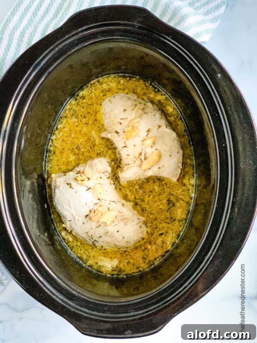 Turkey tenderloins cooking in a crock pot with marinade.