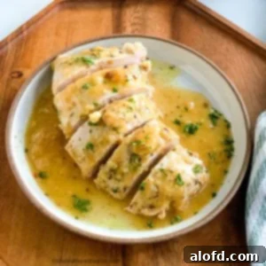 A plate of turkey tenderloin sliced and ready to serve, garnished with herbs.