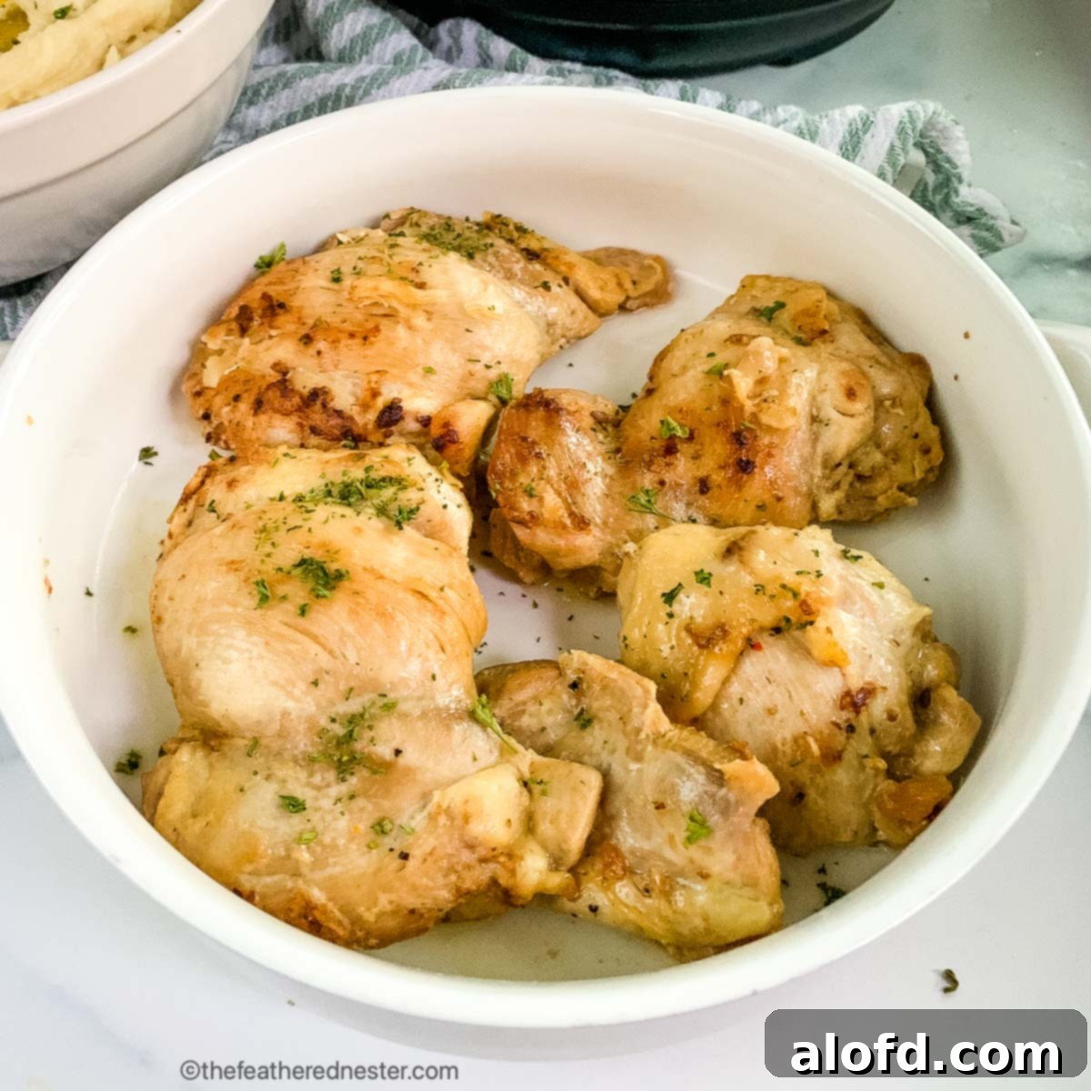 Tender Instant Pot Chicken Thighs and Potatoes 7 A serving platter of pressure cooked chicken.
