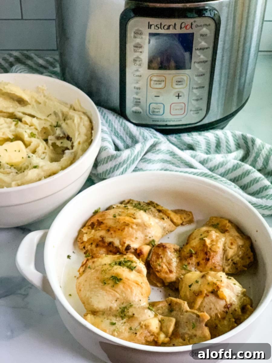 Tender Instant Pot Chicken Thighs and Potatoes 8 A serving platter of chicken thighs and bowl of mashed potatoes with an Instant Pot in the background.