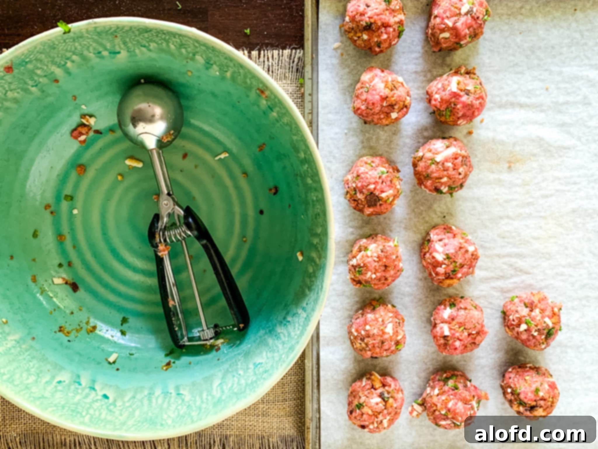 Hearty Meatball Marinara 5 Prepping beef and pork meatballs on a baking sheet, ready for cooking.