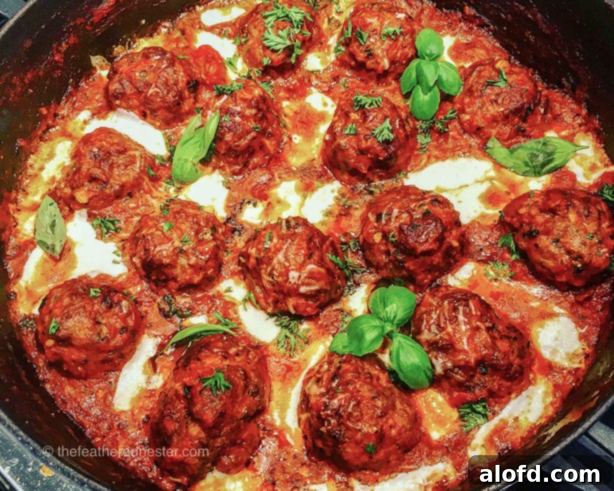 Hearty Meatball Marinara 6 Pork and beef meatballs in a skillet with red sauce and perfectly melted cheese, garnished with fresh basil.