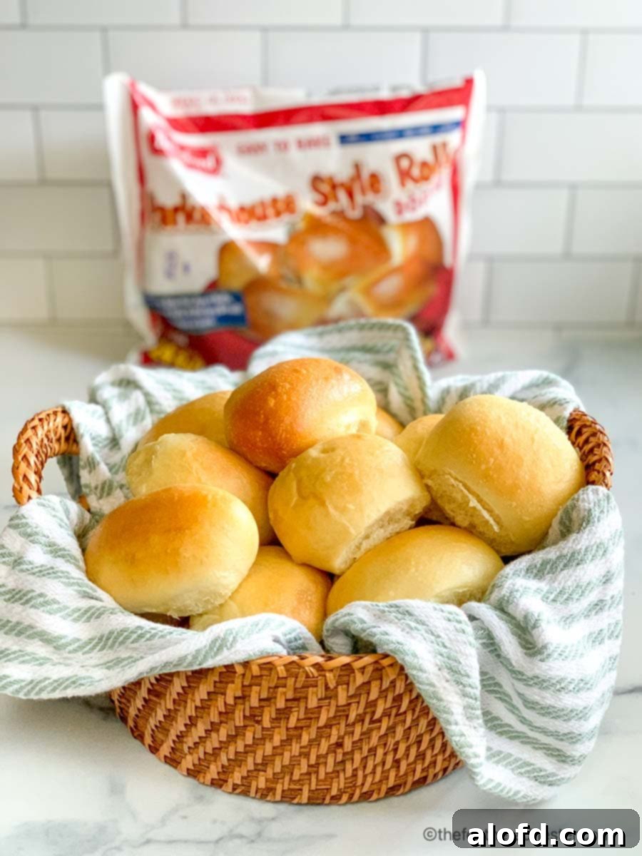 A bag of Bridgford Parker House Rolls next to a basket of freshly baked yeast rolls.