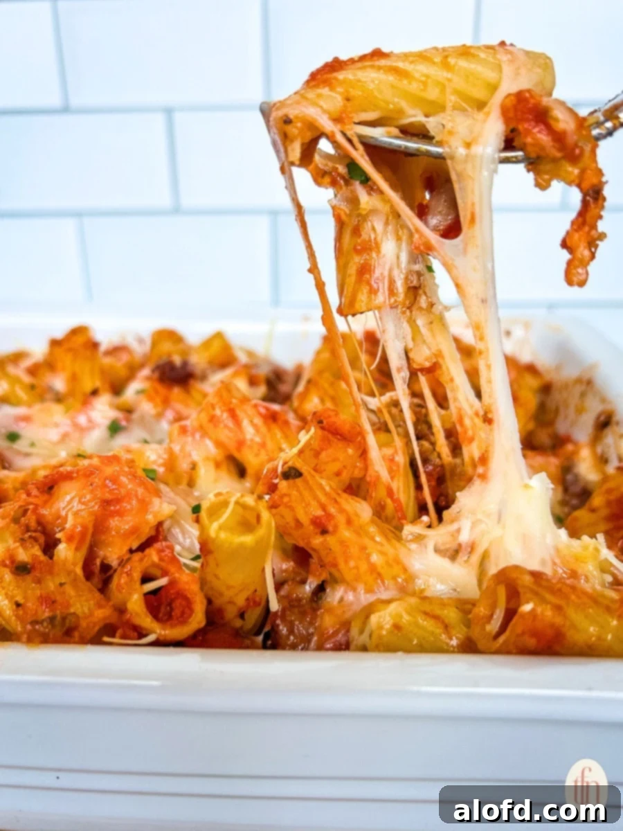 Large dish of cheesy pasta casserole, freshly baked and bubbling.