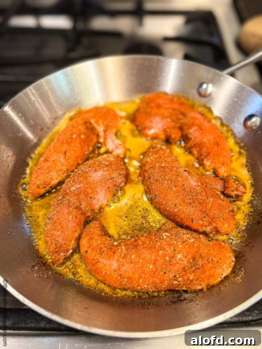 Cajun-Spiced Chicken Strips 7 blackened chicken tenders in a cast iron skillet.