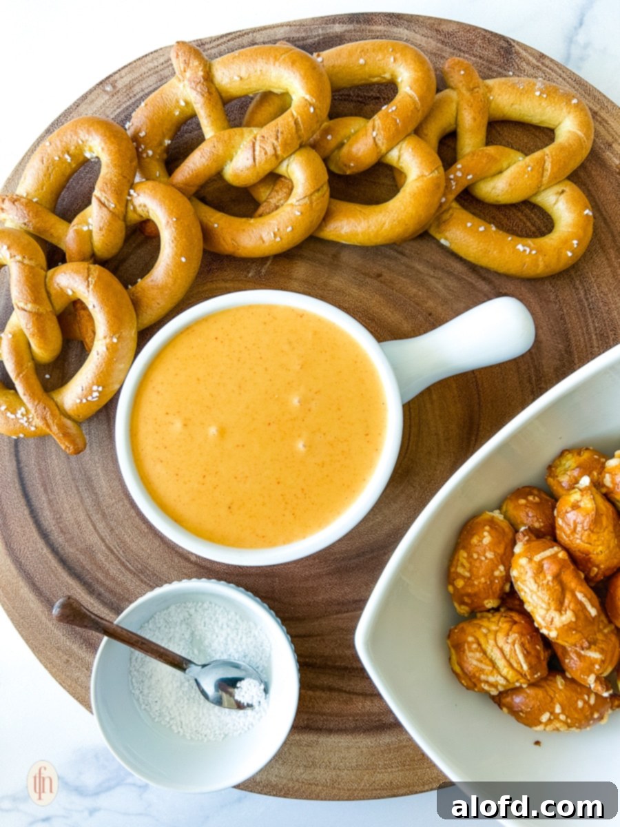 A beautifully arranged serving platter featuring freshly baked pretzels and a bowl of warm, inviting pretzel cheese sauce, ready for dipping.