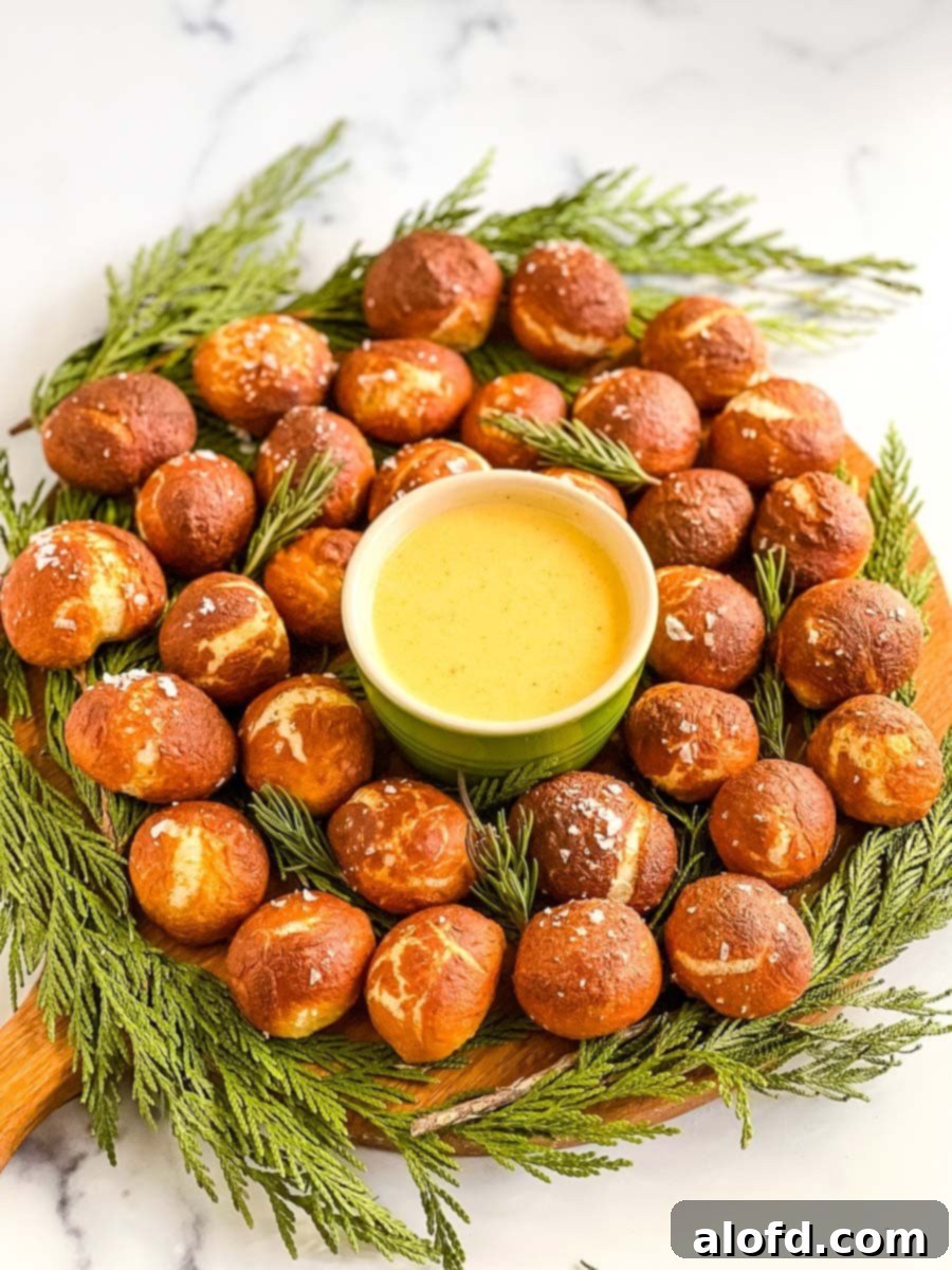 Pretzel Poppers 2 A circle of golden soft pretzel bites with a bowl of cheese dip in the center.