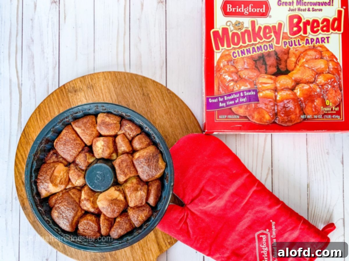 Perfect Bridgford Monkey Bread Made Easy 10 Monkey bread on a pan with a box of monkey bread and a kitchen gloves.