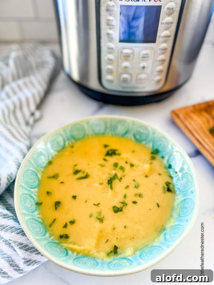 Creamy Instant Pot Acorn Squash Soup 3 A bowl of acorn squash soup with the Instant Pot in the background, ready to be served.