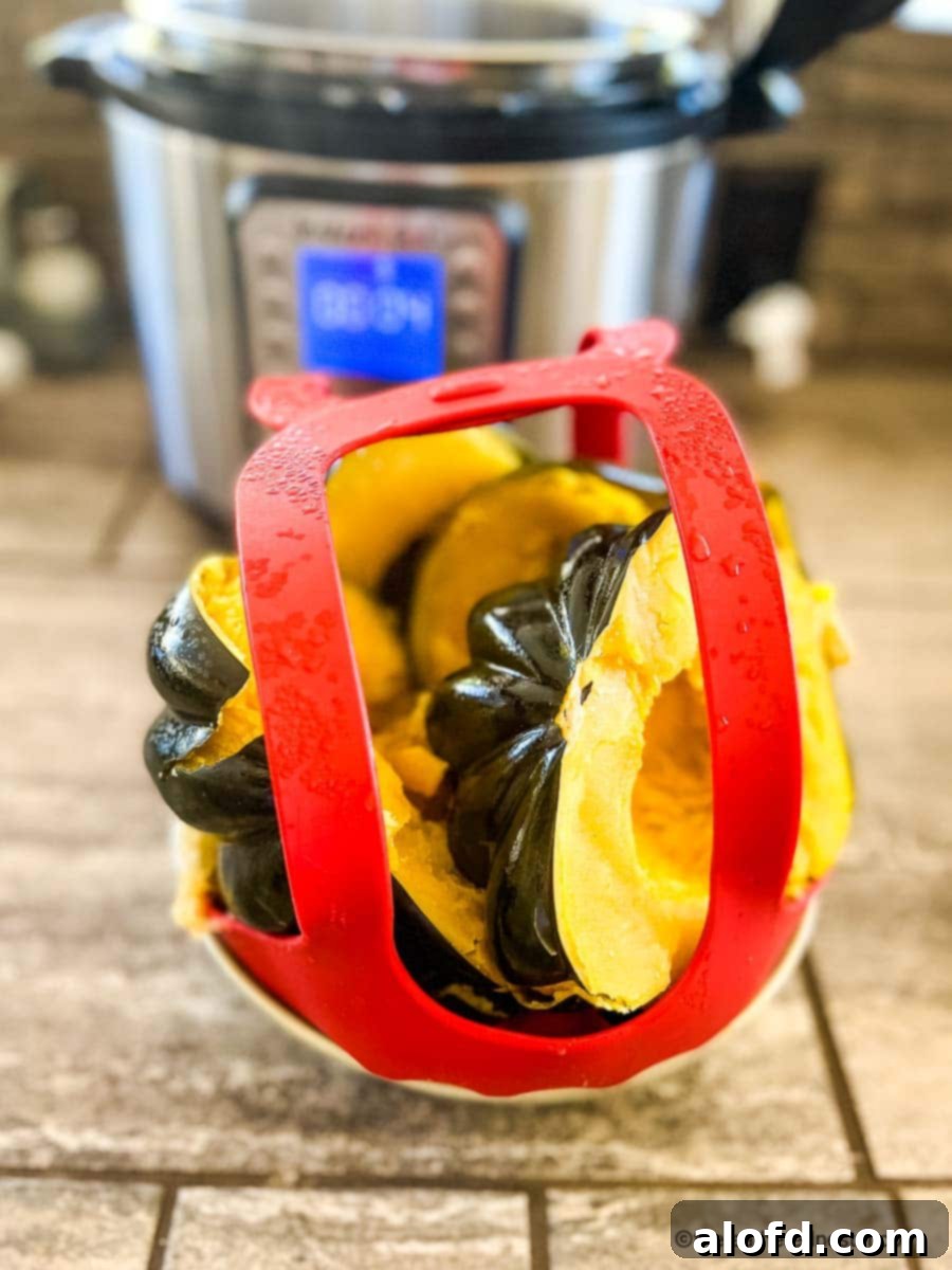 Creamy Instant Pot Acorn Squash Soup 8 Cooked squash in an Instant Pot silicone sling, ready to be lifted out.