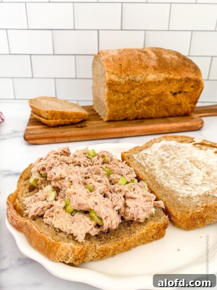 Sliced whole wheat sourdough bread with a delicious filling, highlighting its versatility for meals.