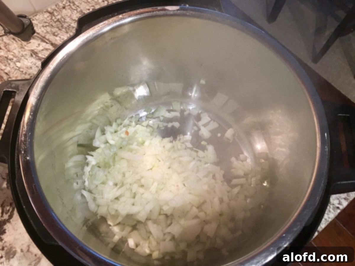 Sautéing diced onions and bell peppers in an Instant Pot before adding other ingredients.