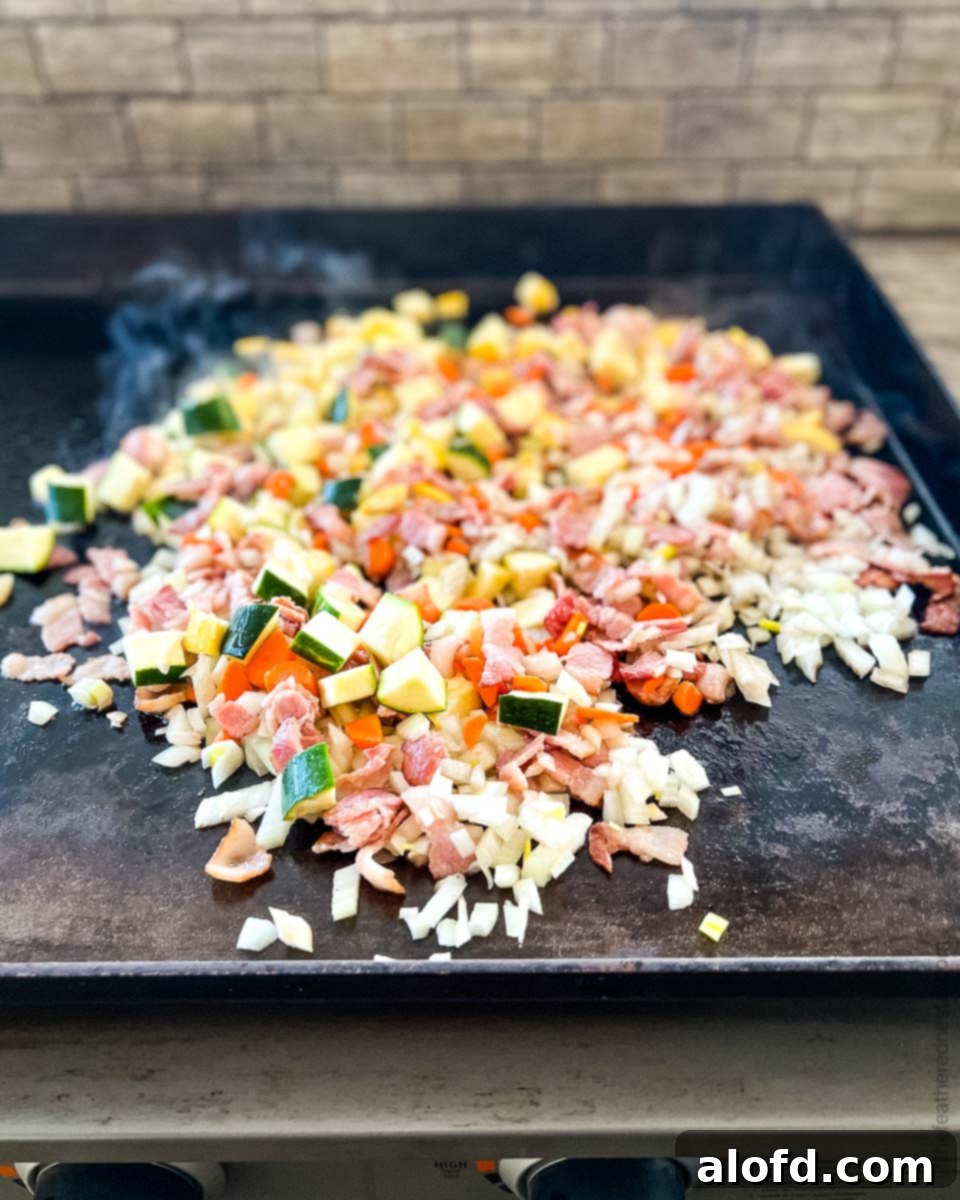 Sizzling Blackstone Fried Rice 7 diced vegetables cooking on the Blackstone Griddle