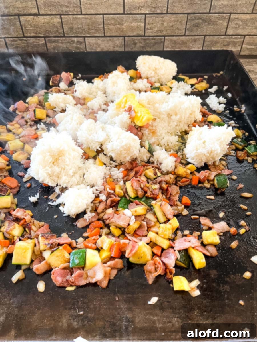 Sizzling Blackstone Fried Rice 9 Making a hibachi fried rice recipe on a flat top griddle.