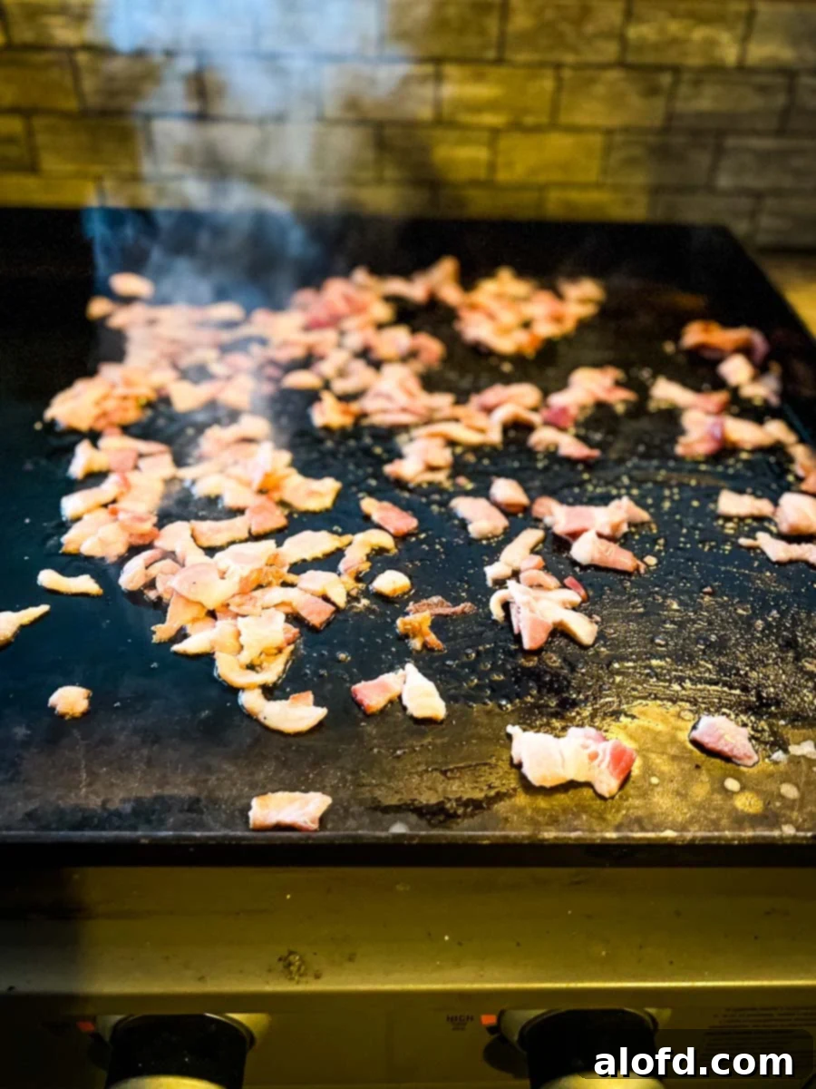 Sizzling Blackstone Chicken Fried Rice 7 bacon cooking on the griddle.