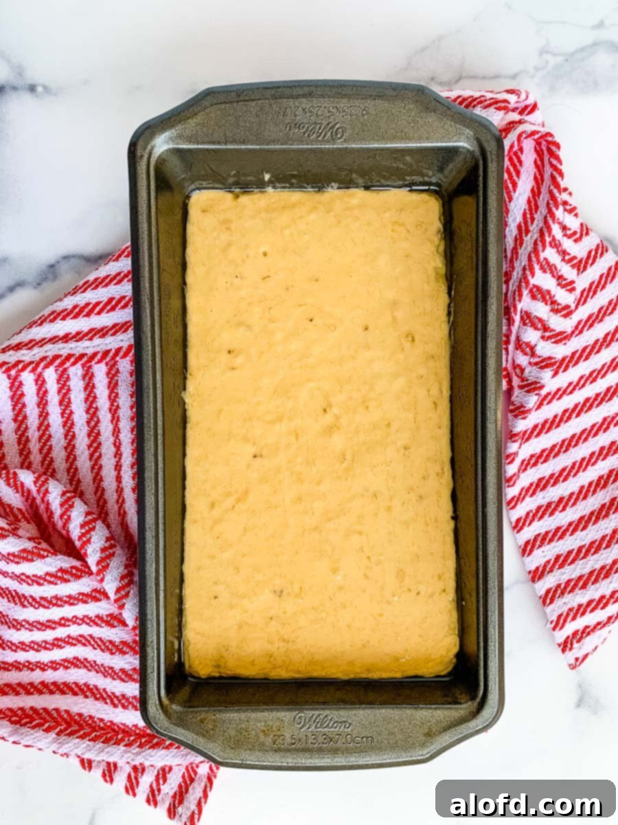 Effortless Self-Rising Banana Bread 7 A loaf pan with banana nut bread with self rising flour batter ready to bake.