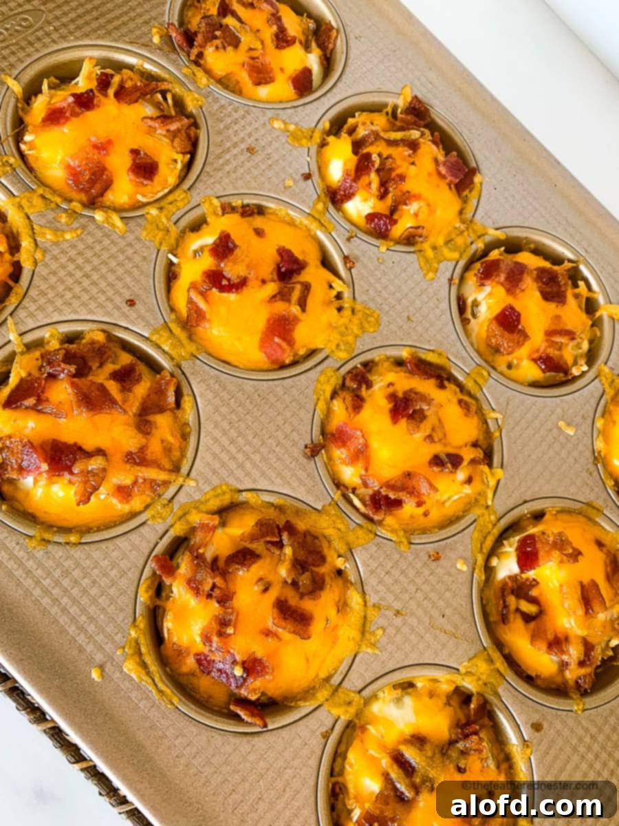 Crispy Hash Brown Egg Cups 12 baked hash brown birds nest egg cups in a muffin pan.