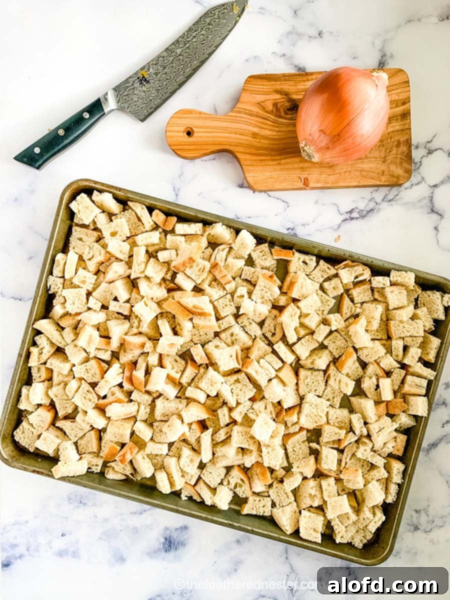 Savory Sourdough Stuffing 3 A baking sheet of uniformly cubed sourdough bread drying, a crucial step for achieving perfect texture in sourdough stuffing.