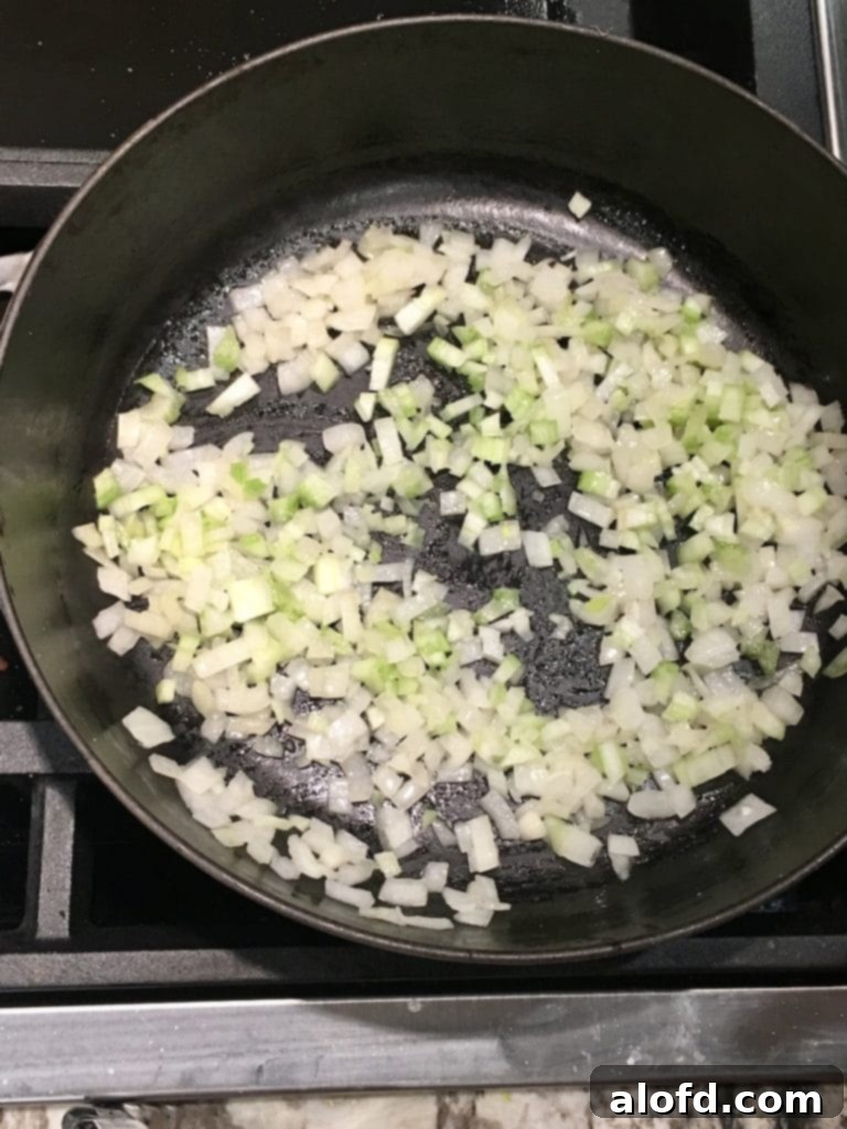 Savory Sourdough Stuffing 5 Freshly chopped onions and celery, meticulously prepared and ready to be sautéed for the best sourdough stuffing recipe.