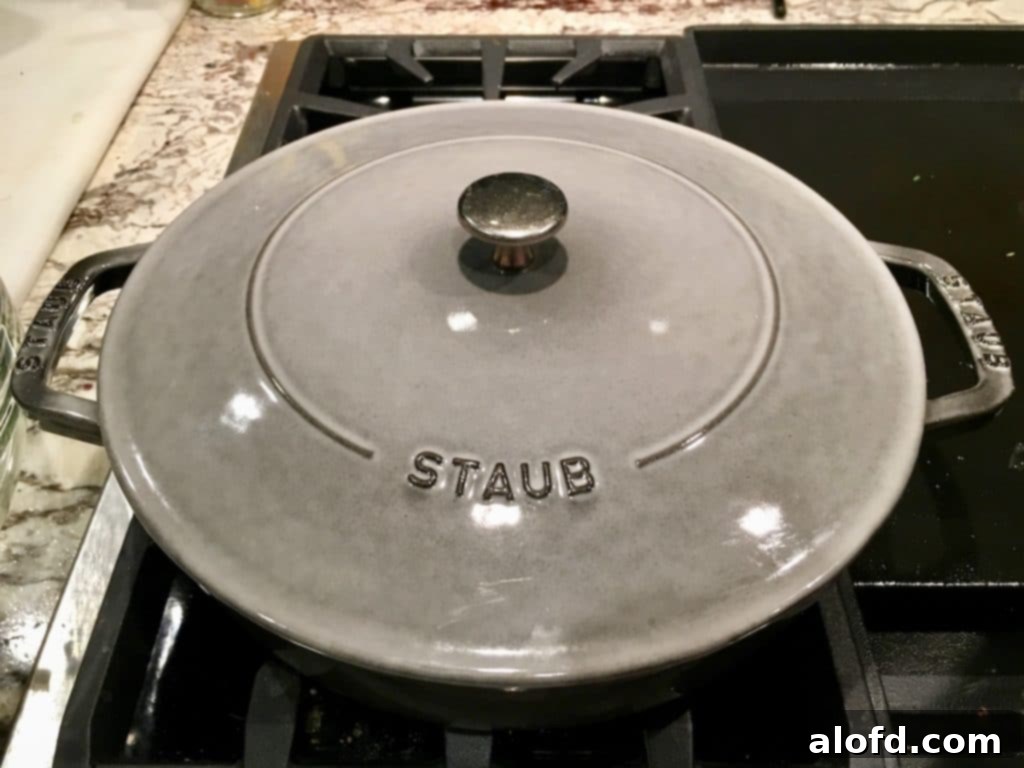 Savory Sourdough Stuffing 6 A Staub braiser pot resting on a stovetop, ready for use in preparing the delicious sourdough stuffing.
