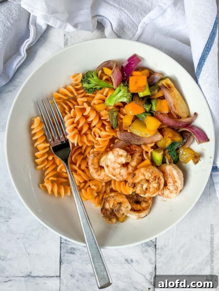 Vibrant Blackstone Veggies 2 A beautifully plated dish of griddle-cooked vegetables, rotini pasta, and shrimp, demonstrating a complete meal cooked on a flat top grill.