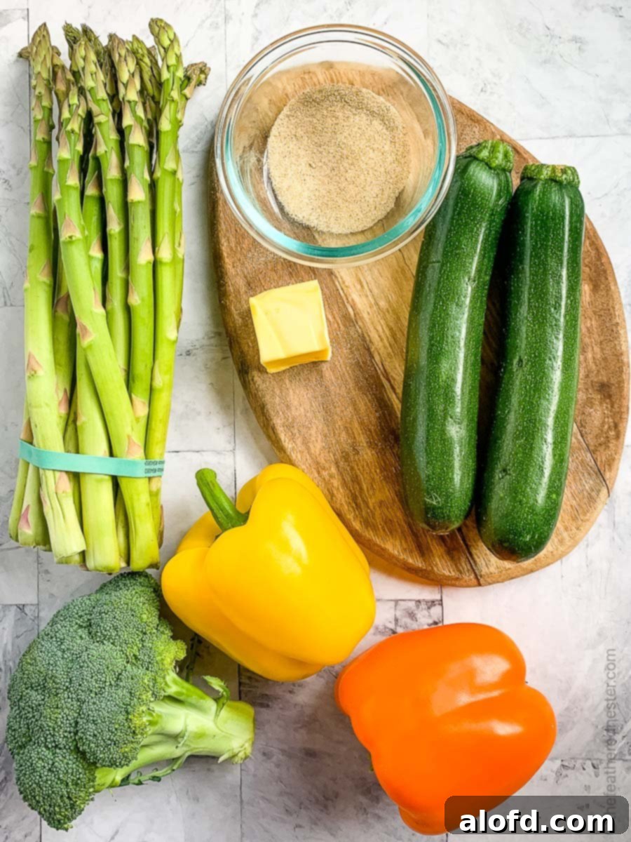 Vibrant Blackstone Veggies 4 A vibrant selection of fresh vegetables including zucchini, bell peppers, broccoli, and asparagus, along with butter and spices, prepared on a wooden cutting board for making Blackstone vegetables.