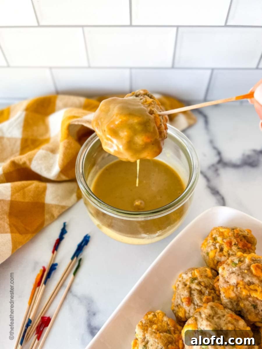 Zesty Honey Mustard Sauce 2 An easy sausage ball being dipped into homemade spicy honey mustard sauce in a clear Weck jar.