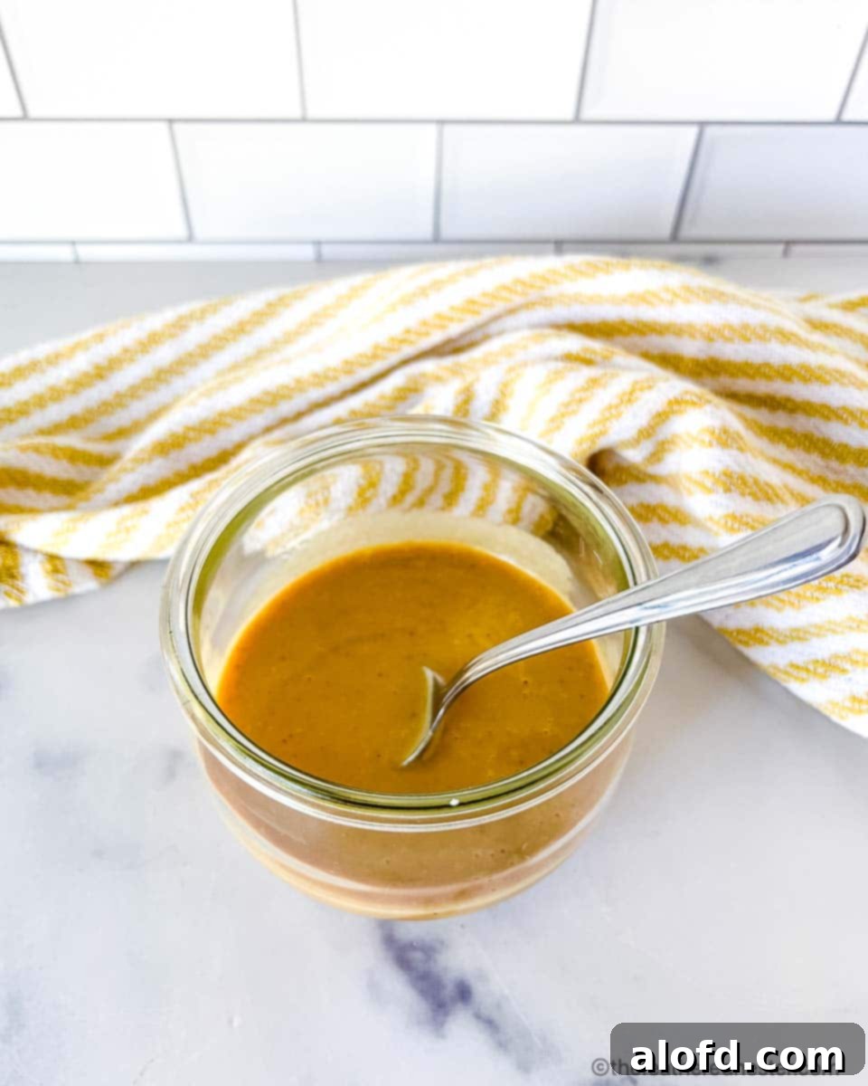 Zesty Honey Mustard Sauce 7 Rich brownish spicy honey mustard sauce in a glass jar.