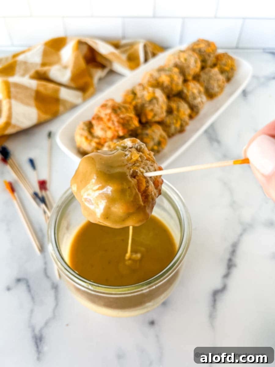 Savory Turkey Sausage Bites 2 Dipping turkey sausage balls into a spicy hot mustard sauce.