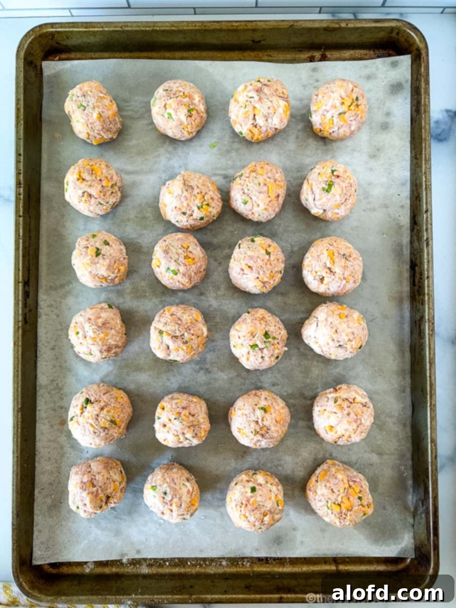 Savory Turkey Sausage Bites 6 Meatball mixture rolled and arranged on a sheet pan, ready to bake in the oven.