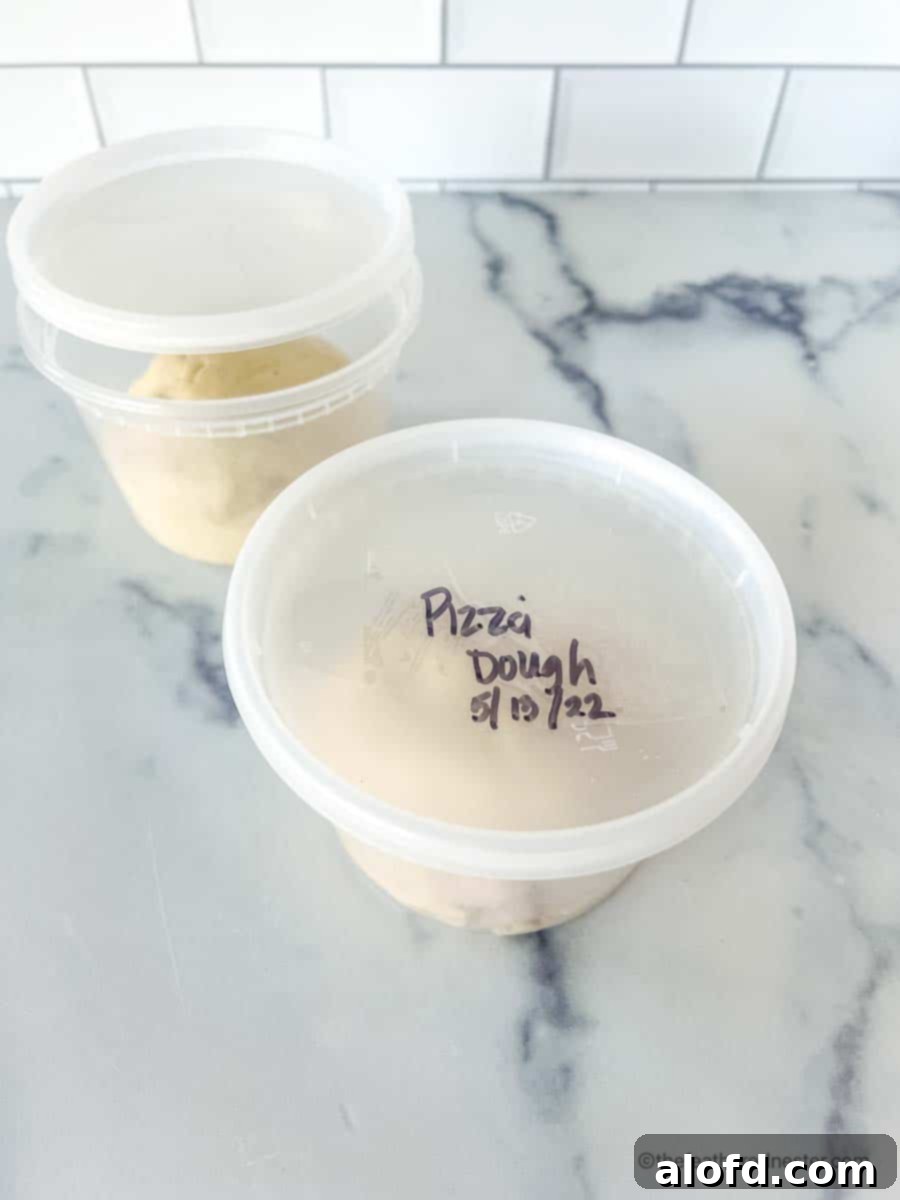 Mastering Pizza Dough Freezing for Future Feasts 4 A clear freezer safe container marked "frozen pizza dough".