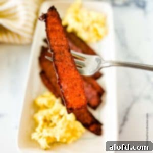 Crispy Oven Turkey Bacon 9 white platter with turkey bacon and scrambled eggs.