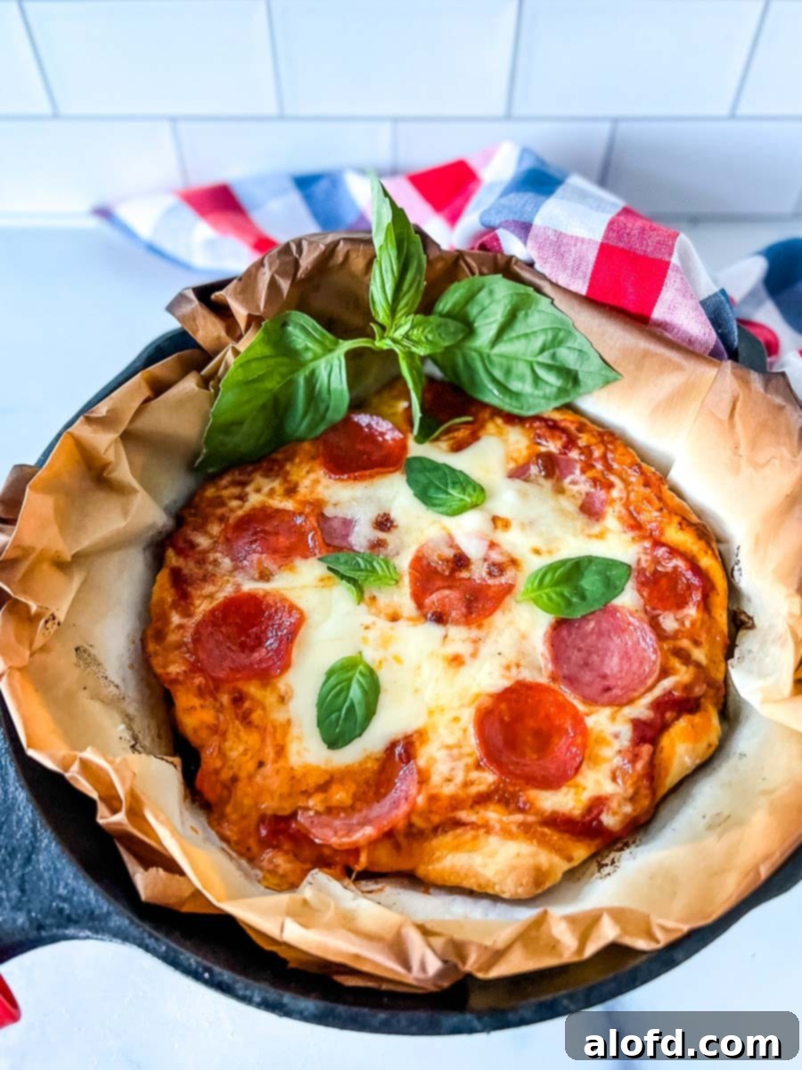 Flame-Kissed Pizza 4 Grilled pizza in a cast iron skillet on parchment paper, garnished with fresh basil.