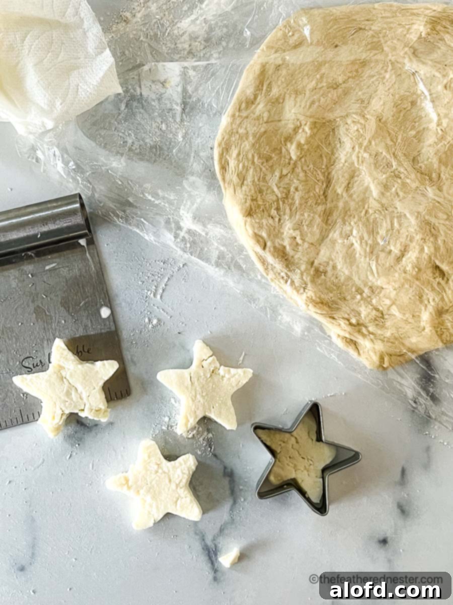 Flame-Kissed Pizza 10 Star-shaped fresh mozzarella cheese slices with a bench scraper, ready for a patriotic pizza.