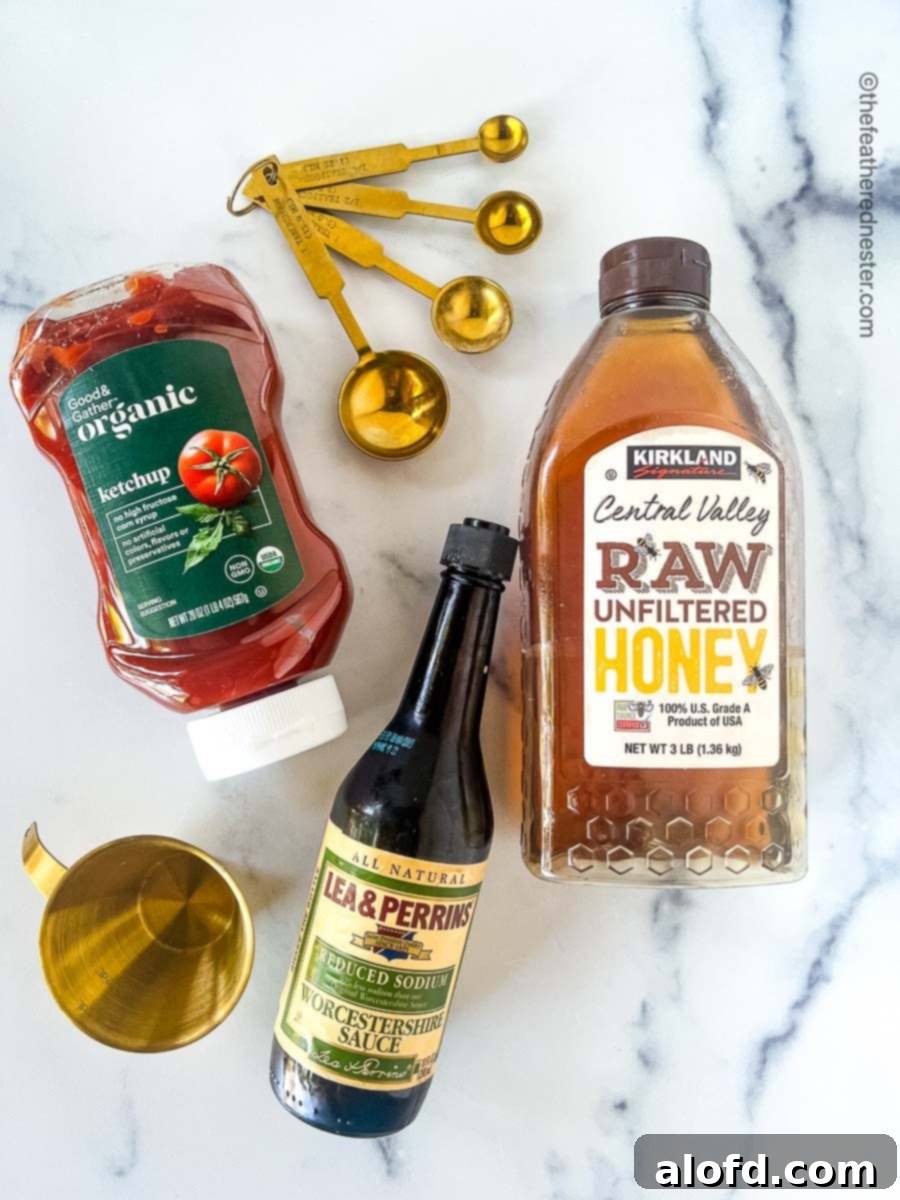 3 Ingredients for the BBQ Sauce, Ketchup, Raw Unfiltered Honey, and Worcestershire Sauce along with the measuring spoon and cup.