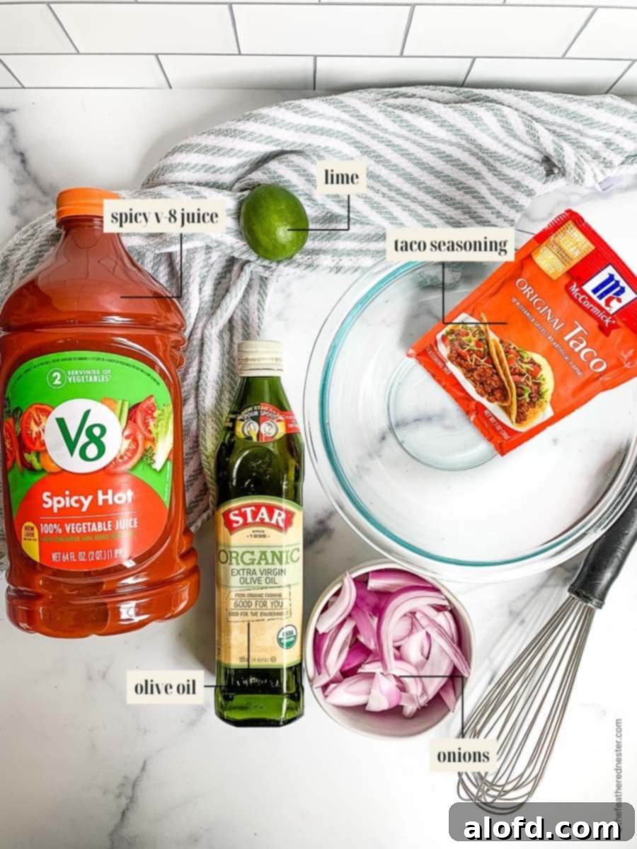 A collection of ingredients for the Blackstone fajitas marinade, including spicy V8 juice, olive oil, fresh lime, taco seasoning, and onions, artfully arranged around a mixing bowl and whisk.