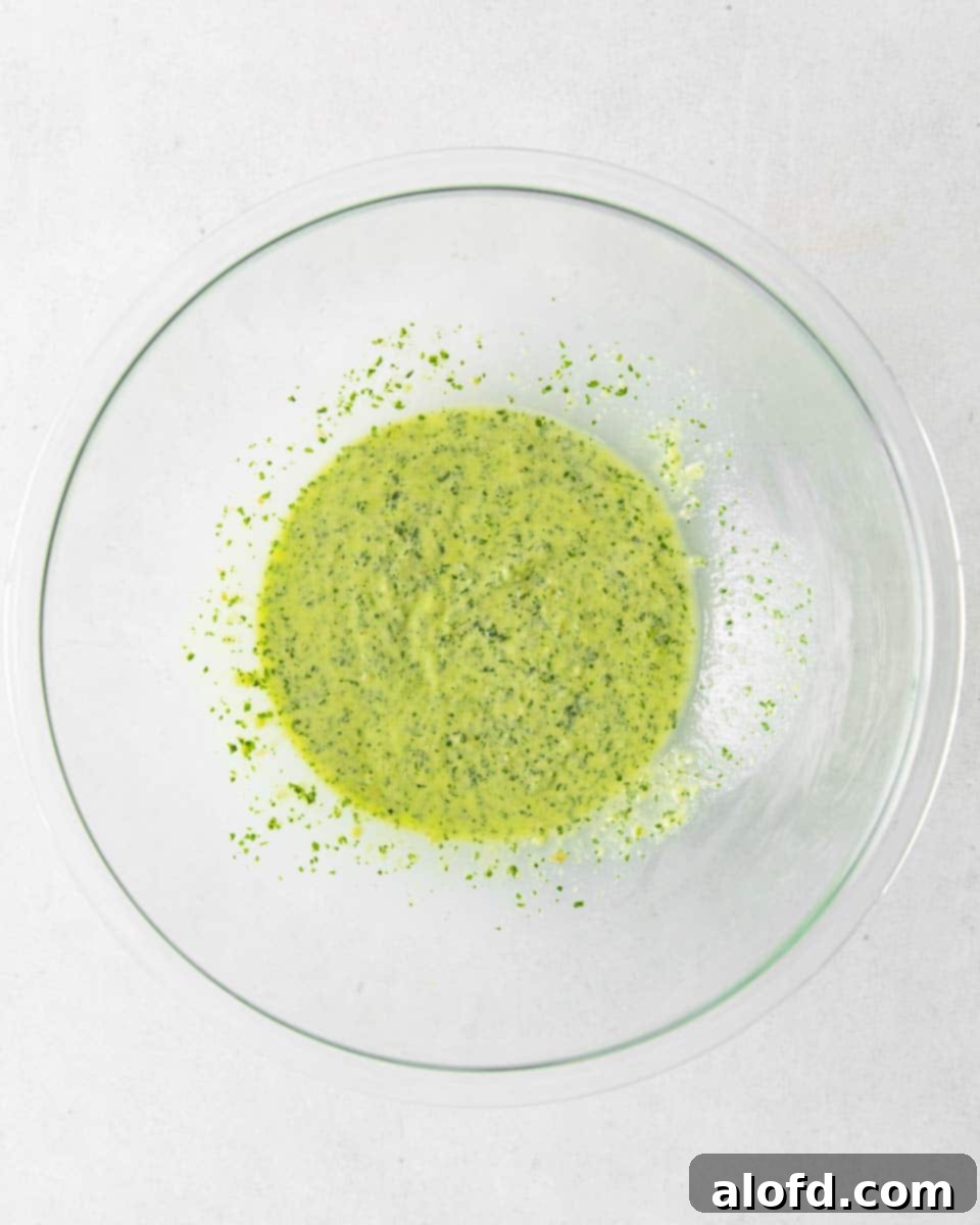 Spring Pea Pasta 9 Smooth, processed pesto sauce resting in a large mixing bowl, ready to be combined with pasta.