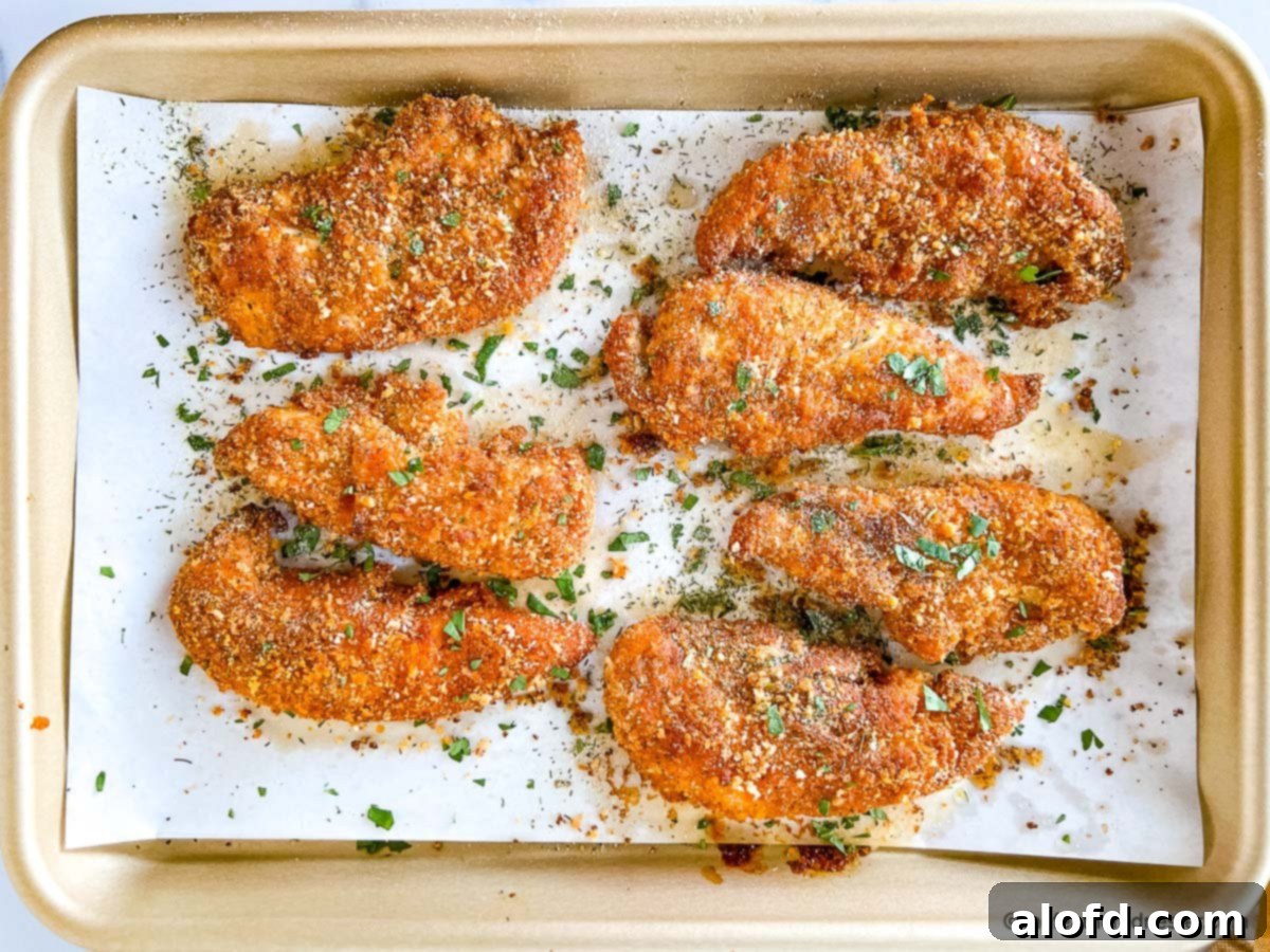 Shake and bake chicken pieces on top of parchment paper lined baking tray.