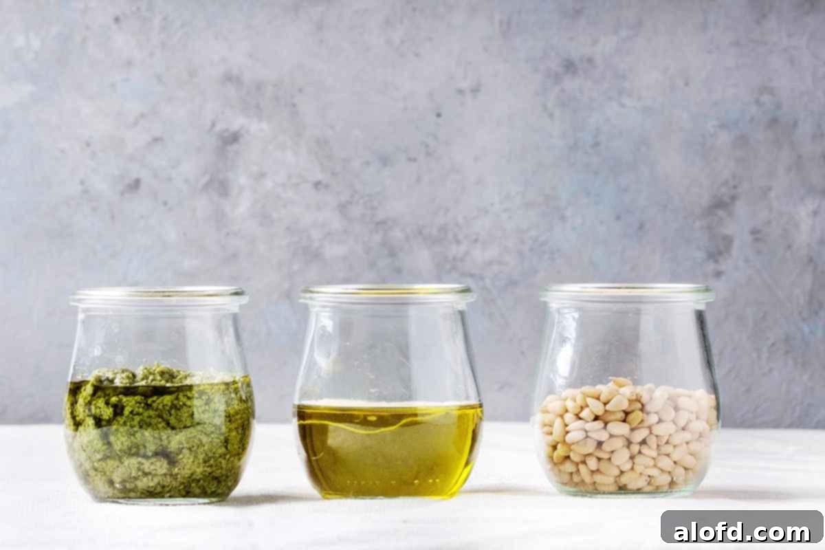 Emerald Herb Pesto 8 Three clear jars filled with homemade pesto sauce, extra virgin olive oil, and toasted pine nuts, highlighting the fresh, natural ingredients.
