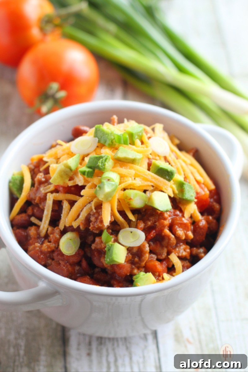 Hearty Skillet Chili 3 Serving of ground beef and kidney bean stew in a white bowl.